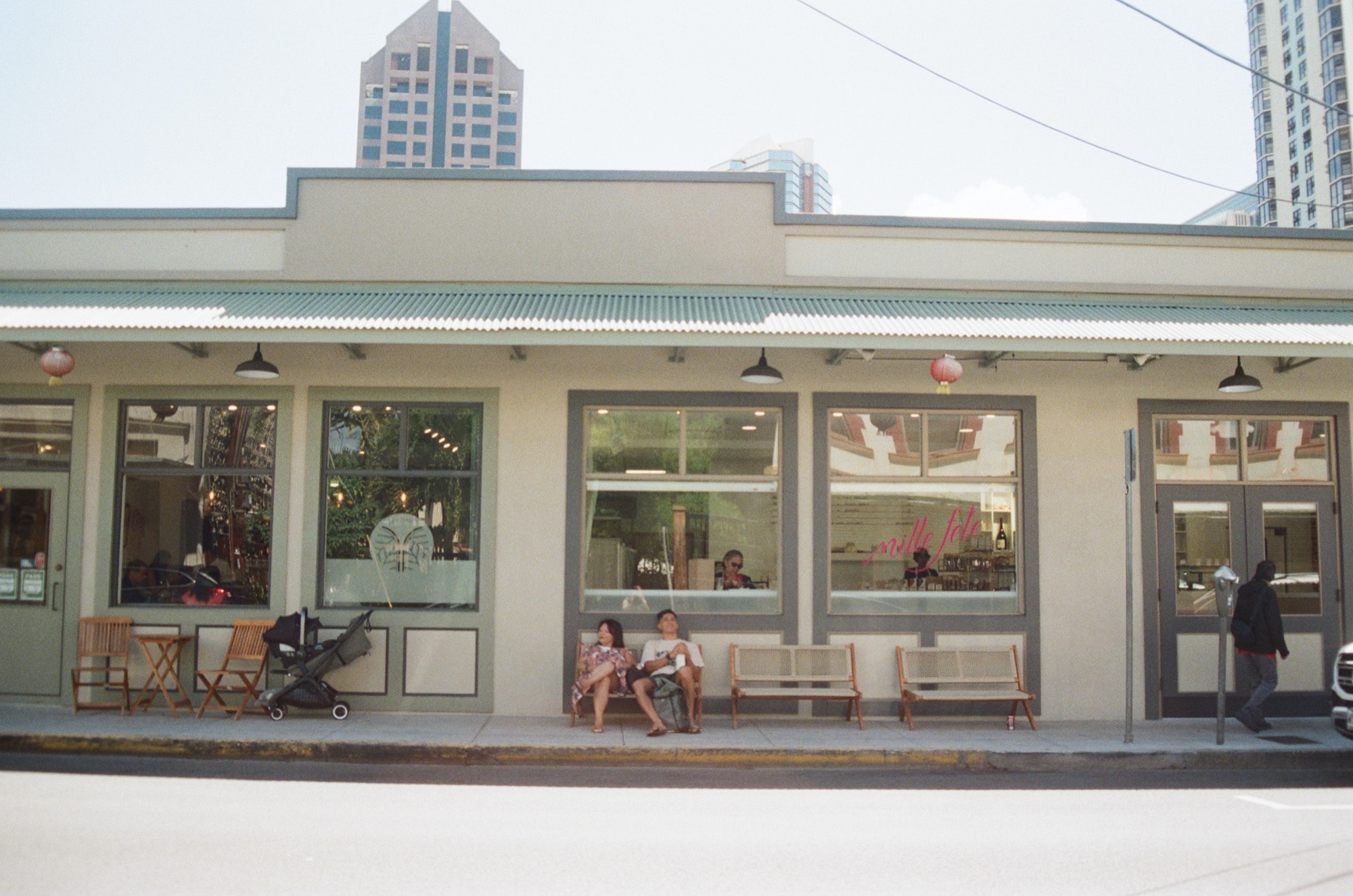 A storefront in Honolulu's Chinatown, city towers rising behind.